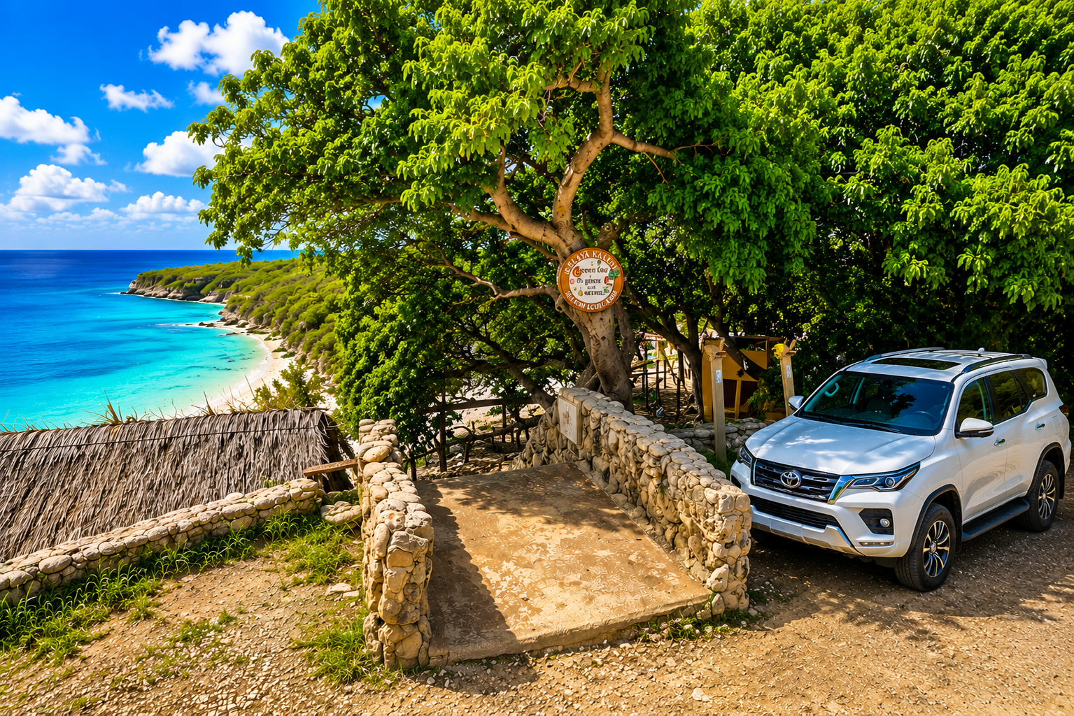 Family rental car with scenic coastal view at Playa Kalki, Westpunt
